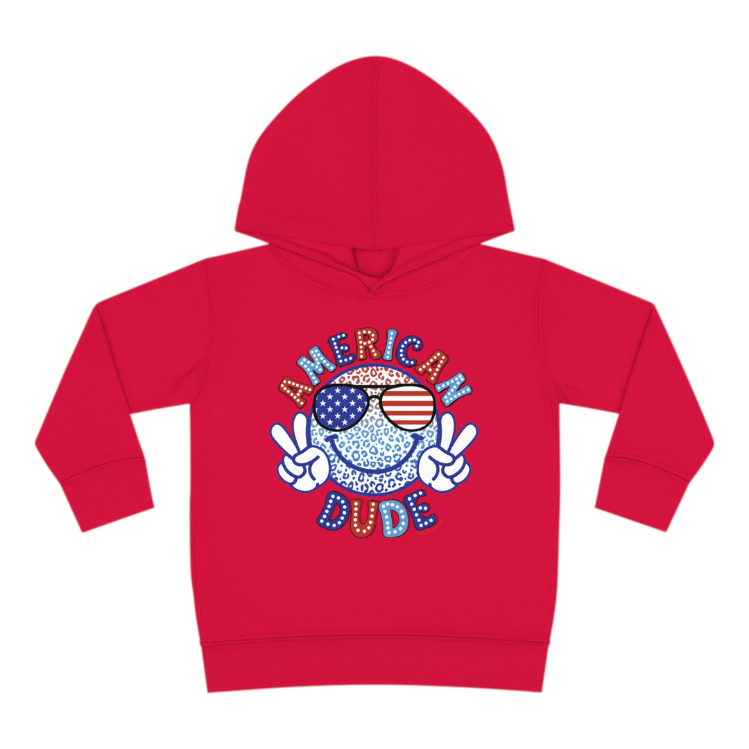 American Dude Toddler Hoodie featuring a smiley face and sunglasses cartoon character design. Jersey-lined hood, cover-stitched details, and side seam pockets for durability and coziness. Ideal for toddlers.