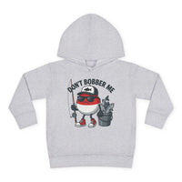 Don't Bobber Me Toddler Hoodie features a cartoon fishing bobber with sunglasses and fishing gear, emphasizing playful design and comfort for kids.