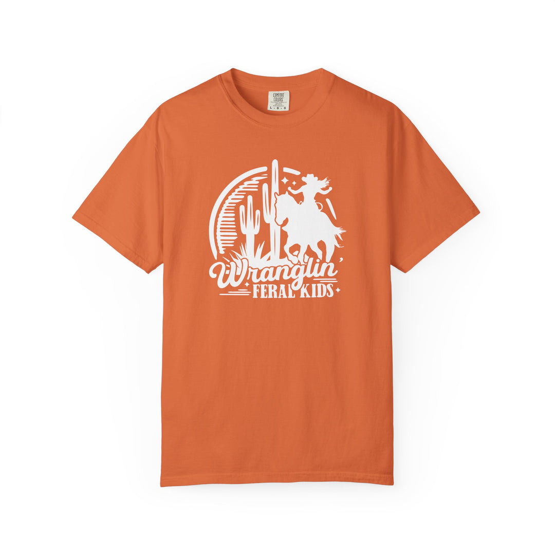 Wranglin’ Feral Kids Tee features a Western-themed graphic of a youngster on a bucking horse, perfect for adding humor and style to any casual wardrobe.