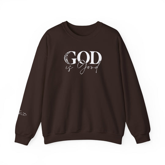 A brown God is Good Crew sweatshirt with white text, made of a cozy 50% cotton and 50% polyester blend. Features ribbed knit collar, classic fit, and durable double-needle stitching. No itchy side seams for ultimate comfort.