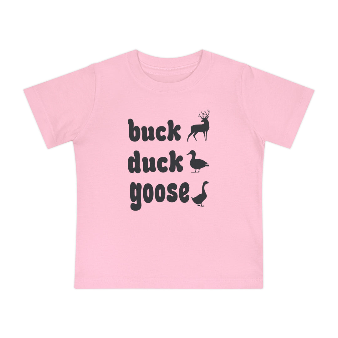 Buck, Duck, Goose Baby Tee features playful animal silhouettes alongside bold text on a light-pink T-shirt, offering a unique twist on a classic game.