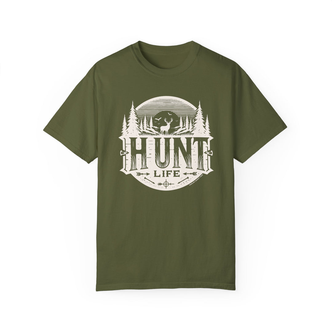 A Hunt Life Tee: Green shirt with white deer and tree logo. 100% ring-spun cotton, garment-dyed for coziness. Relaxed fit, double-needle stitching for durability. Ideal for daily wear.