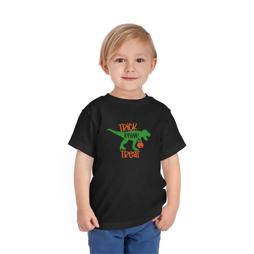 A Trick Rawr Treat Toddler Tee featuring a child in a black shirt with a green dinosaur design. Made of 100% Airlume combed cotton for comfort. From Worlds Worst Tees.