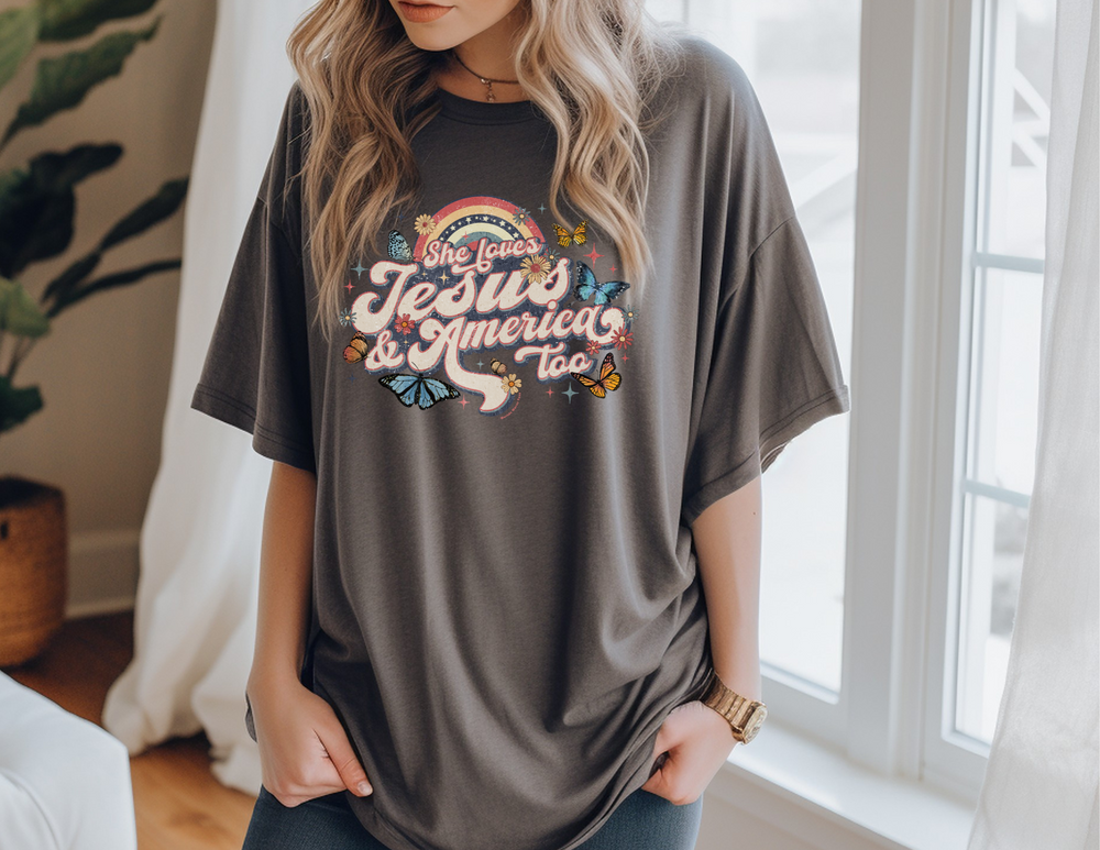 A classic She Loves Jesus and America Tee in soft cotton with ribbed knit collars and taping for durability. Unisex fit, retail style, 100% Airlume combed cotton. Sizes XS to 3XL.