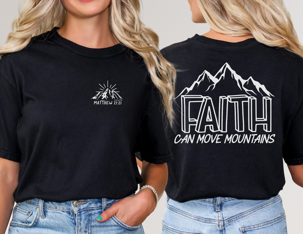 A black tee with Faith Can Move Mountains text, worn by a woman. Unisex fit, 100% cotton, ribbed knit collar, tear-away label. From Worlds Worst Tees.