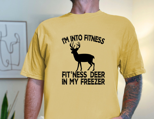 A yellow tee featuring a deer silhouette, part of the Gildan 5000 collection. Unisex, heavy cotton fabric with ribbed knit collar for elasticity. Ideal for casual fashion.