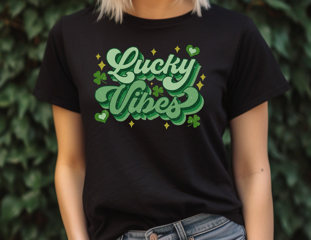 A Lucky Vibes Tee, featuring a woman in a black shirt, close-ups of jeans, a belly, and an arm. Unisex jersey tee made of 100% cotton, with ribbed knit collars and taping on shoulders for a comfy fit.