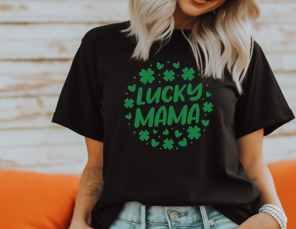 A Lucky Mama Tee, a black shirt with green text, featuring a woman smiling. Unisex jersey tee with ribbed knit collars, 100% cotton, light fabric, and tear-away label. Retail fit, true to size.