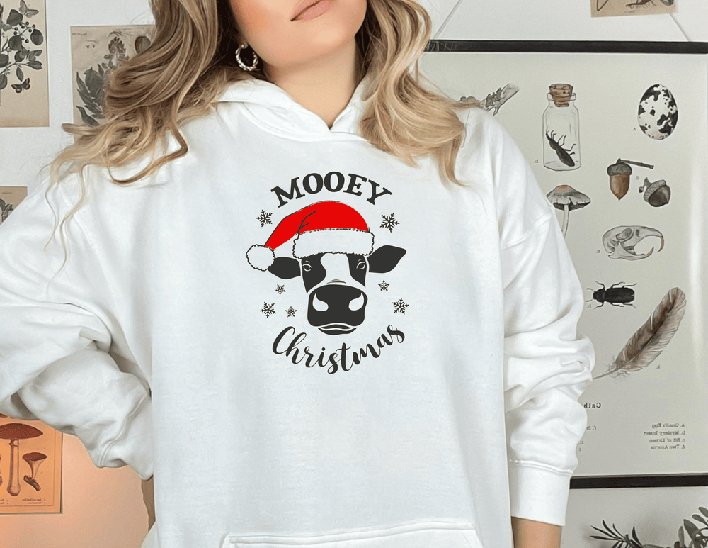 A cozy unisex heavy blend hooded sweatshirt featuring a whimsical cow design for the MOOEY CHRISTMAS HOODIE. Thick cotton-polyester fabric, kangaroo pocket, and drawstring hood. Perfect for warmth and comfort.