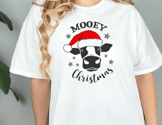 A unisex jersey tee featuring a cow wearing a Santa hat, part of the Mooey Christmas Tee collection. Soft cotton, ribbed knit collars, and Airlume combed cotton ensure a comfortable fit.