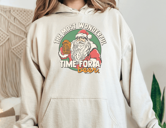 Unisex Most Wonderful Time for a Beer Hoodie, featuring Santa Claus design on white sweatshirt. Thick cotton-polyester blend, kangaroo pocket, and drawstring hood. Classic fit, tear-away label, cozy warmth.