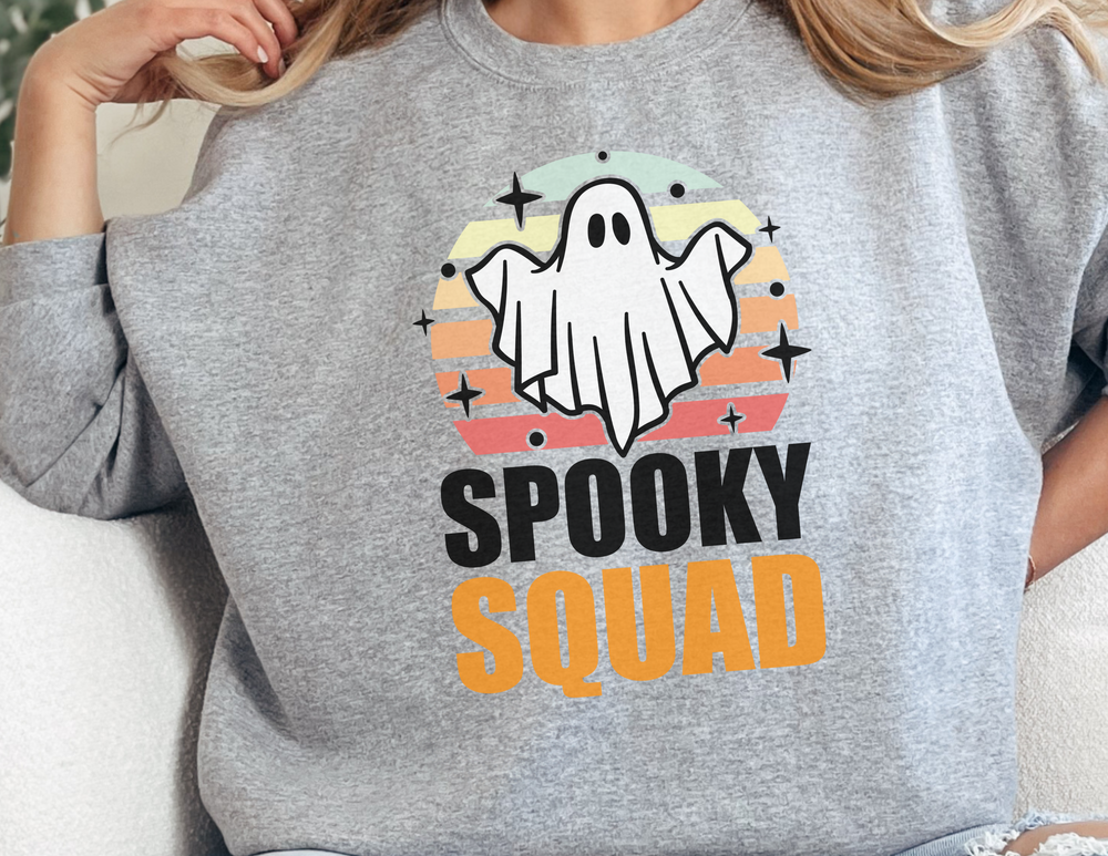Unisex Spooky Squad Crewneck Sweatshirt featuring a ghost graphic on grey fabric. Comfortable blend of polyester and cotton, ribbed knit collar, no itchy seams. Medium-heavy fabric, loose fit, true to size.