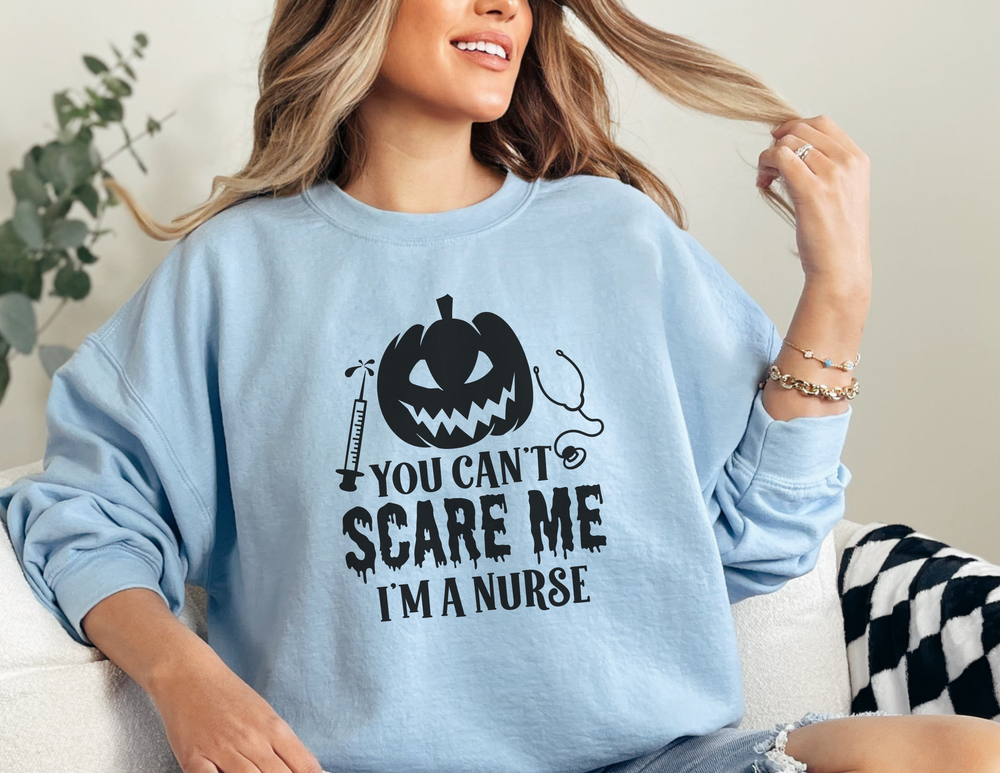 A unisex heavy blend crewneck sweatshirt featuring the title You Can't Scare a Nurse. Made of 50% cotton and 50% polyester, with ribbed knit collar for shape retention. Comfortable, loose fit, and true to size.
