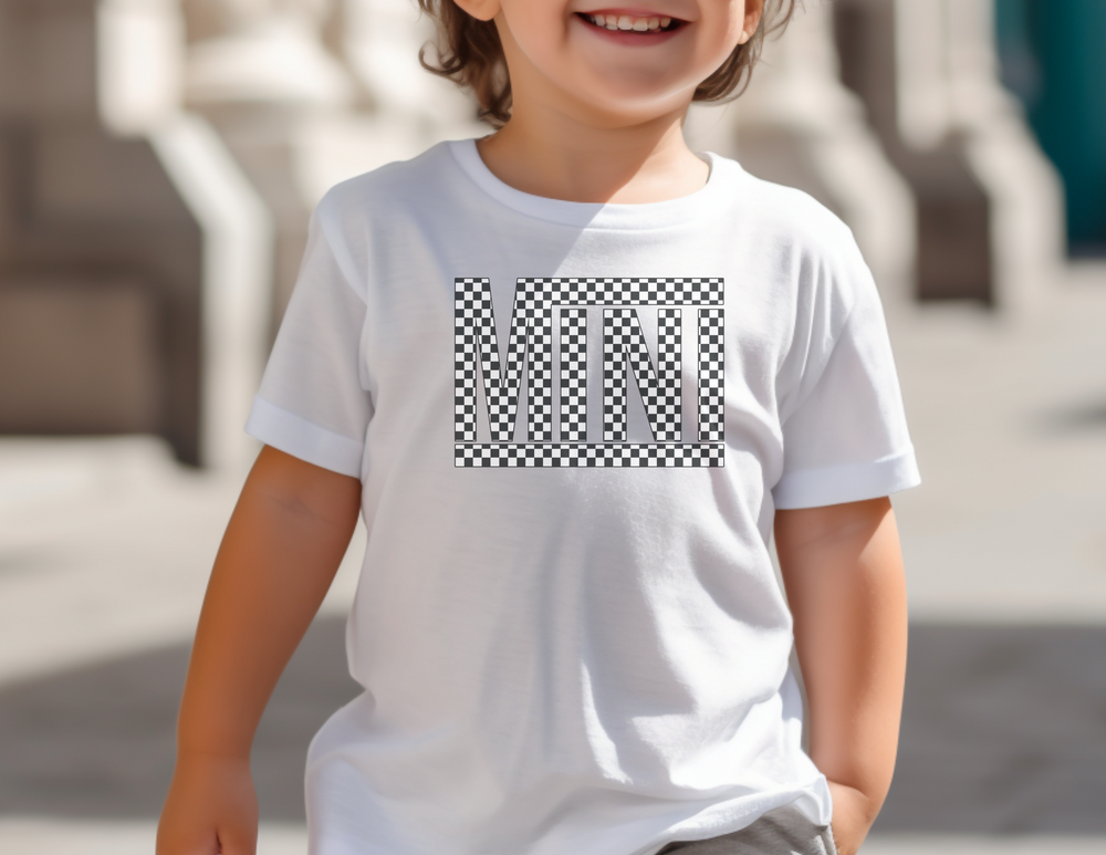 A smiling child in a white Vans Mini Toddler Tee, showcasing comfort and durability for sensitive skin. Made of 100% combed cotton, light fabric, with a classic fit, ideal for little adventurers.