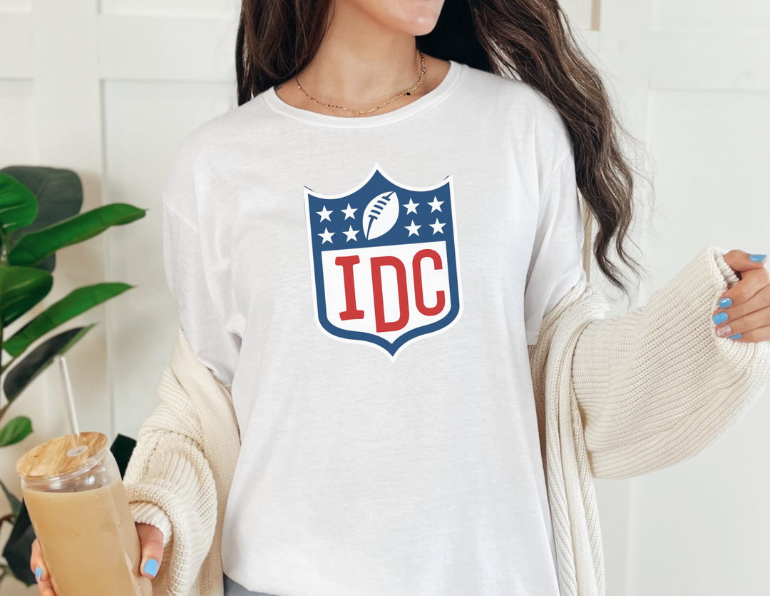 A woman in a white NFL I Don't Know Long Sleeve Tee, featuring a classic fit, taped shoulders, and no side seams. Made of 100% cotton for comfort. Ideal for casual wear.