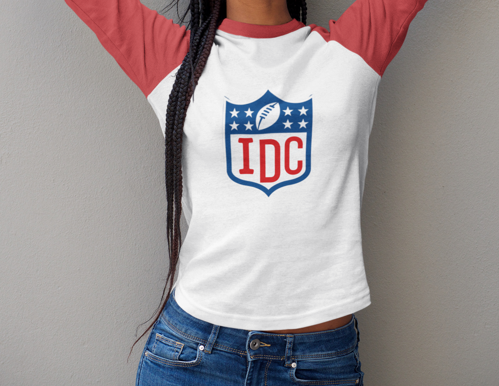 A unisex NFL I Don't Care 3/4 Raglan Tee with loose fit Raglan sleeves. Features a logo of a football team. Made of polyester, cotton, and rayon blend. Ideal for a stylish home run.
