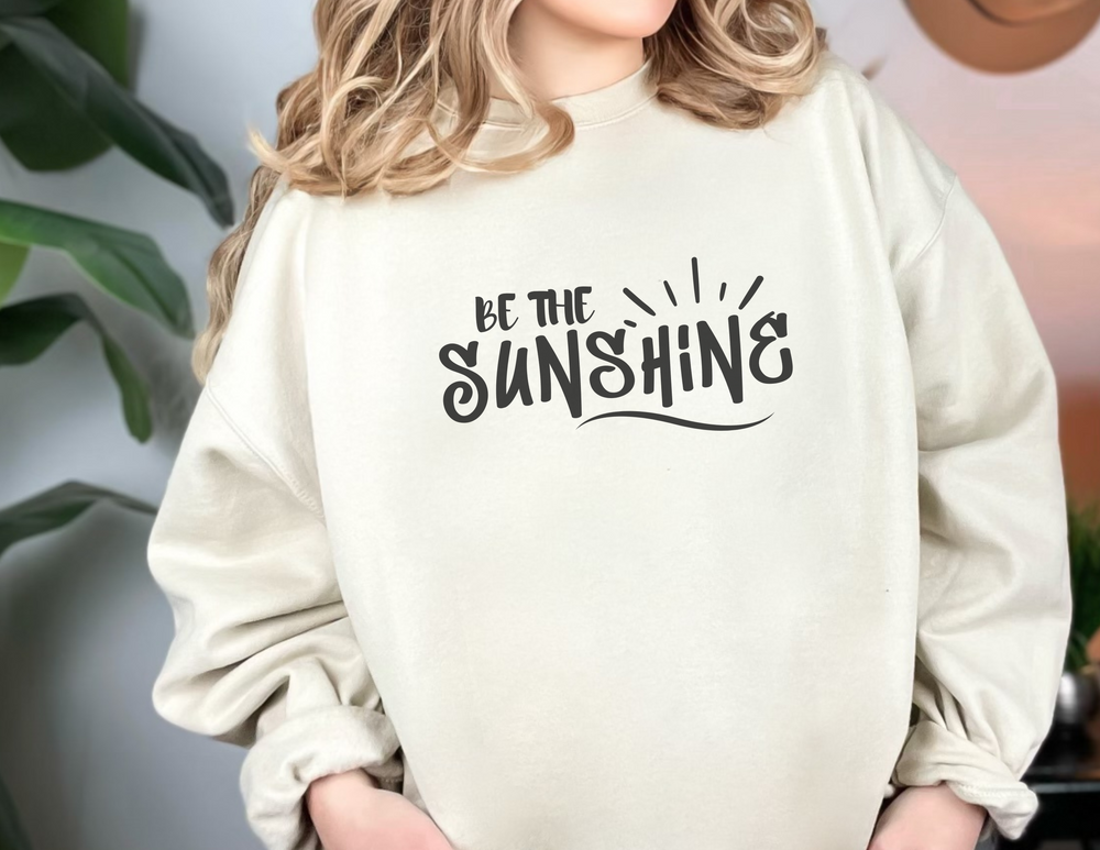 A unisex heavy blend crewneck sweatshirt featuring the Be The Sunshine design. Made of 50% cotton and 50% polyester, with a ribbed knit collar and no itchy side seams. Medium-heavy fabric, loose fit, and sewn-in label.