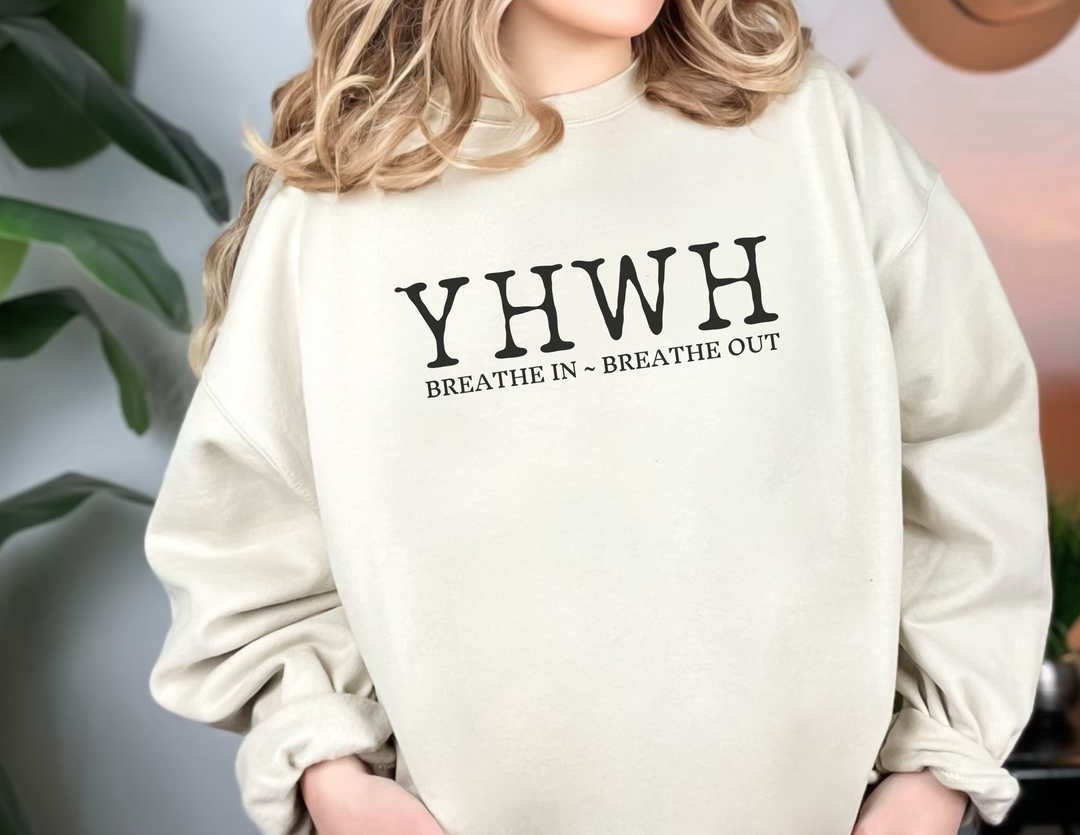 A unisex YHWH Crewneck sweatshirt in white, featuring a ribbed knit collar and no itchy side seams. Made of 50% cotton and 50% polyester, with a loose fit and medium-heavy fabric.