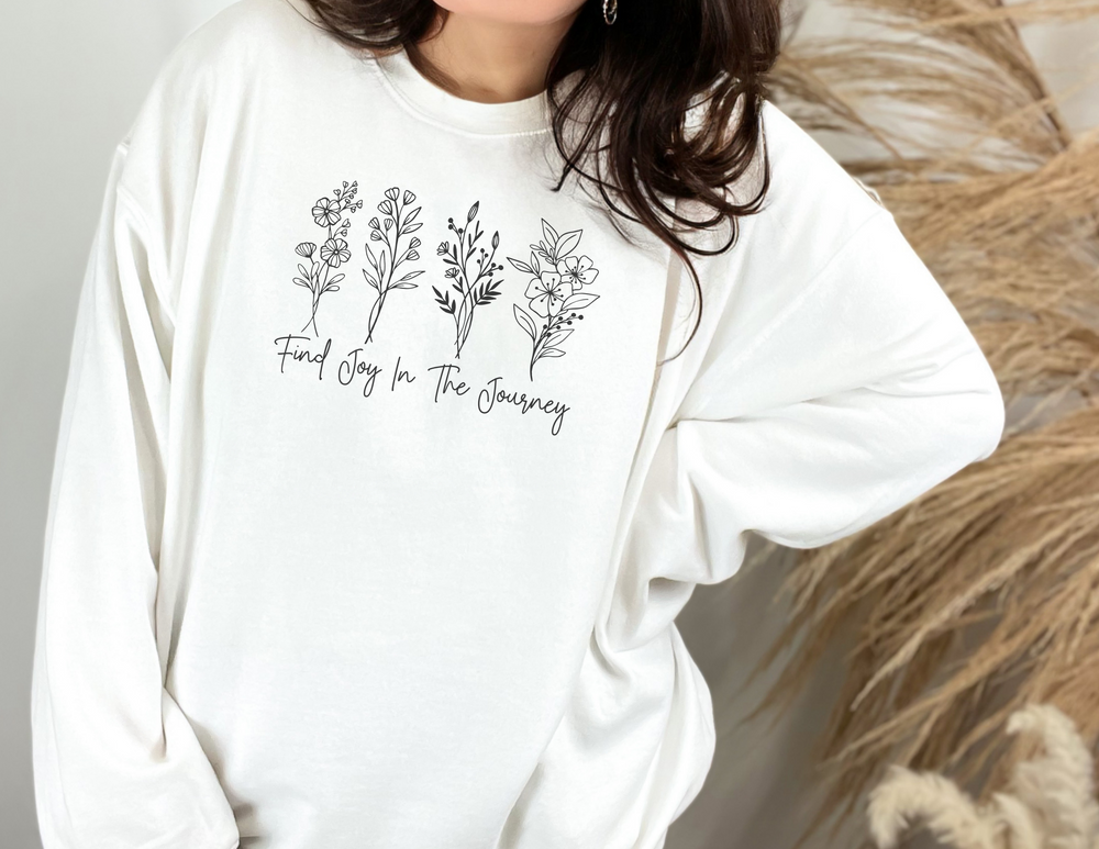A unisex heavy blend crewneck sweatshirt featuring the Find Joy in the Journey Crew design. Made of 50% cotton, 50% polyester with ribbed knit collar, no itchy side seams, and a loose fit.