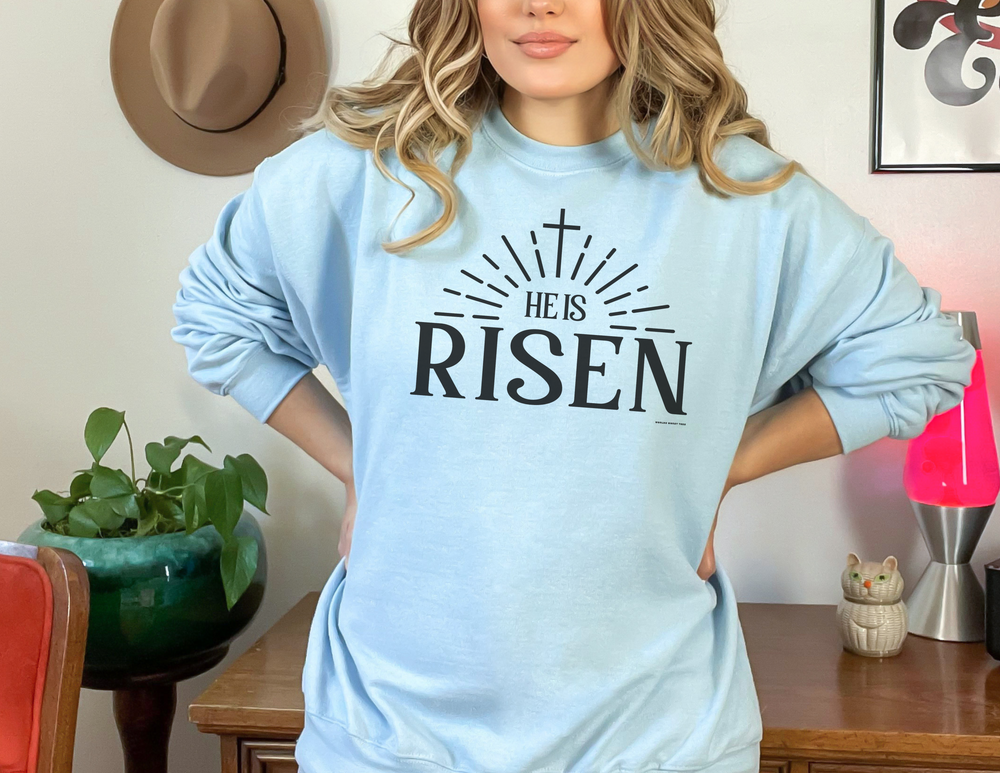 A unisex heavy blend crewneck sweatshirt featuring the He is Risen Crew design. Made from 50% cotton and 50% polyester, with ribbed knit collar and double-needle stitching for durability. Ideal for colder months.