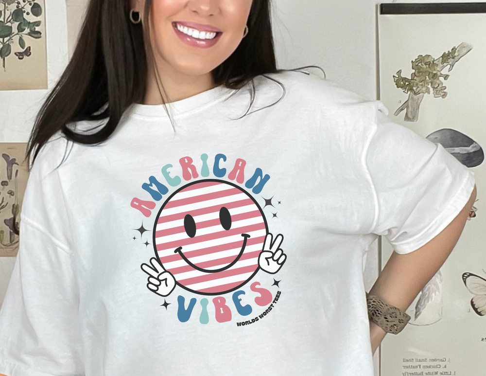 A relaxed fit American Vibes Tee in ring-spun cotton, featuring a smiling woman in a white shirt. Medium weight, garment-dyed for coziness and durability. Ideal for daily wear.