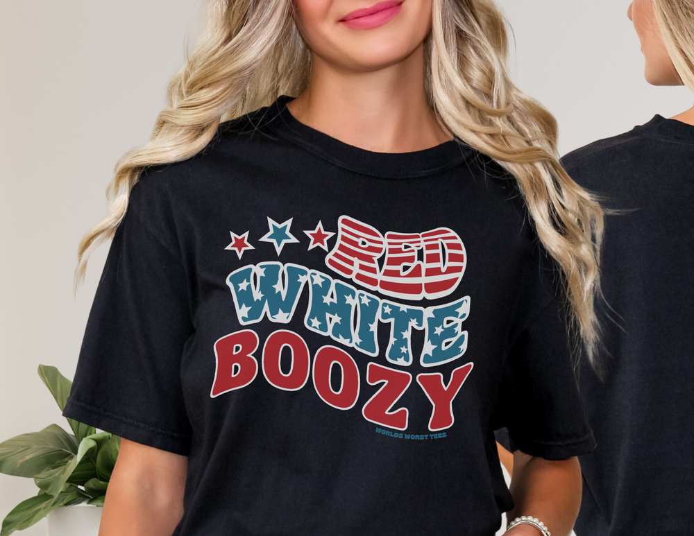 A woman smiles at the camera in a close-up of the Red White and Boozy Tee. Unisex heavy cotton shirt with no side seams, ribbed knit collar, and durable tape on shoulders. Classic fit, 100% cotton.