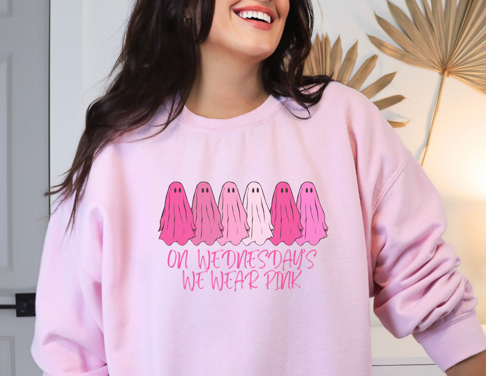 A comfortable unisex crewneck sweatshirt featuring the On Wednesday's We Wear Pink design. Made of 50% cotton and 50% polyester, with ribbed knit collar and no itchy side seams. Medium-heavy fabric, loose fit, and sewn-in label.