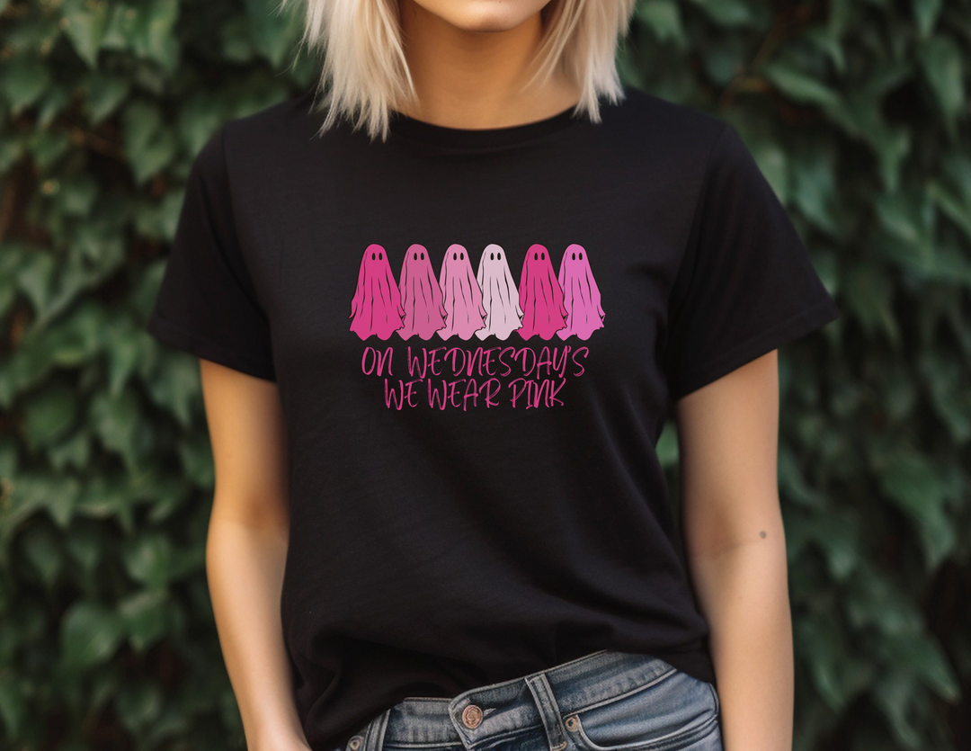 Unisex Hammer™ T-shirt featuring a woman in a black shirt, a group of pink ghosts, and cartoon faces. Made of 100% pre-shrunk cotton with a modern-classic fit. From 'Worlds Worst Tees'.