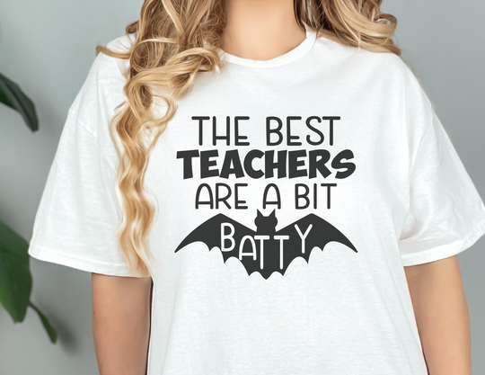 A classic unisex jersey tee featuring a woman in a white shirt with black text and a bat design. Made of 100% cotton, with ribbed knit collars and taping on shoulders for a better fit. From Worlds Worst Tees.