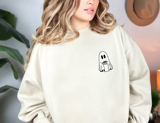 A unisex Ghost Coffee Crew Crew sweatshirt in white, featuring a ghost holding a coffee cup. Made of 50% cotton and 50% polyester with a ribbed knit collar and no itchy side seams. Sizes from S to 5XL.