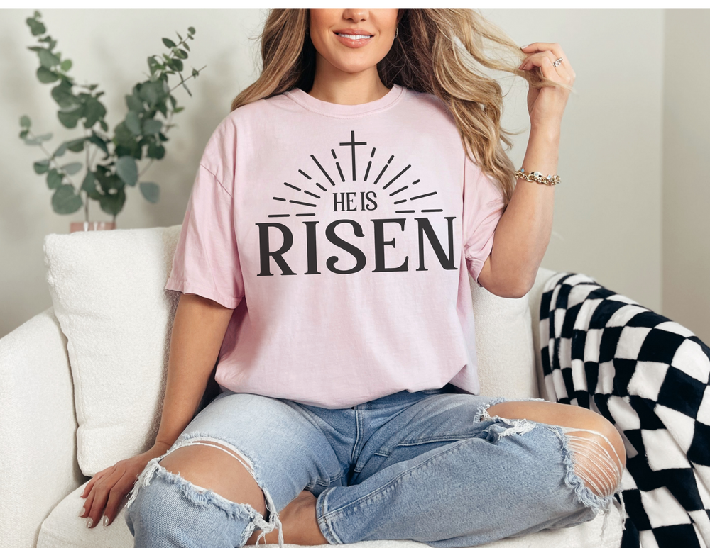 A relaxed fit He is Risen Tee, crafted from 100% ring-spun cotton for ultimate comfort. Garment-dyed with double-needle stitching for durability, this tee features a tubular shape without side-seams.