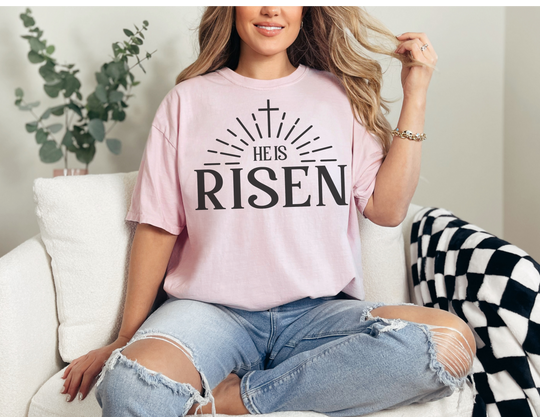 A relaxed fit He is Risen Tee, crafted from 100% ring-spun cotton for ultimate comfort. Garment-dyed with double-needle stitching for durability, this tee features a tubular shape without side-seams.