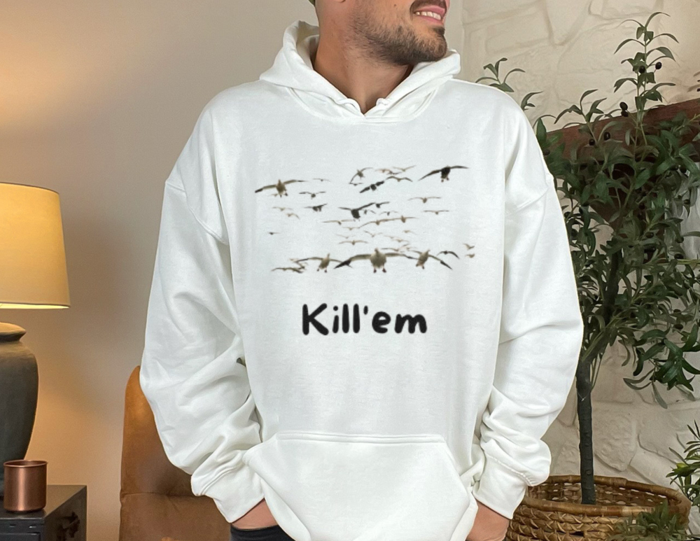 A man in a Kill'em Snows Hoodie, featuring birds, a kangaroo pocket, and drawstring hood. Unisex, cotton-polyester blend, no side seams, medium-heavy fabric, tear-away label, classic fit. Sizes S-5XL.