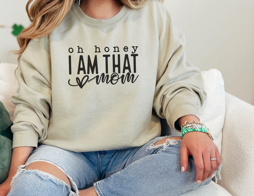 A unisex heavy blend crewneck sweatshirt, featuring the title Oh Honey I'm that Mom Crew. Made of 50% cotton, 50% polyester with ribbed knit collar. Loose fit, medium-heavy fabric. Sizes S-5XL.