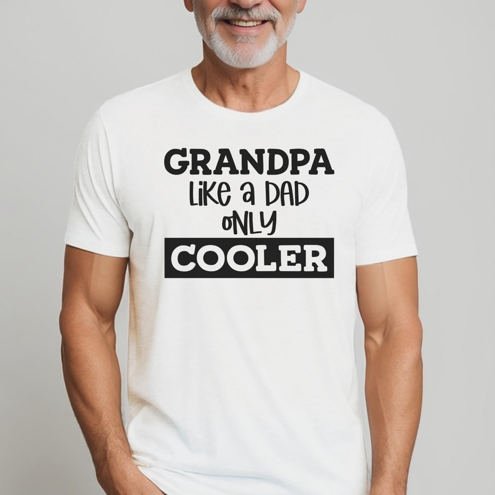 A man in a white shirt, showcasing the Grandpa Like Dad but Cooler Tee from Worlds Worst Tees. Premium fit, ribbed knit collar, 100% cotton fabric. Comfy and light for workouts or daily wear.