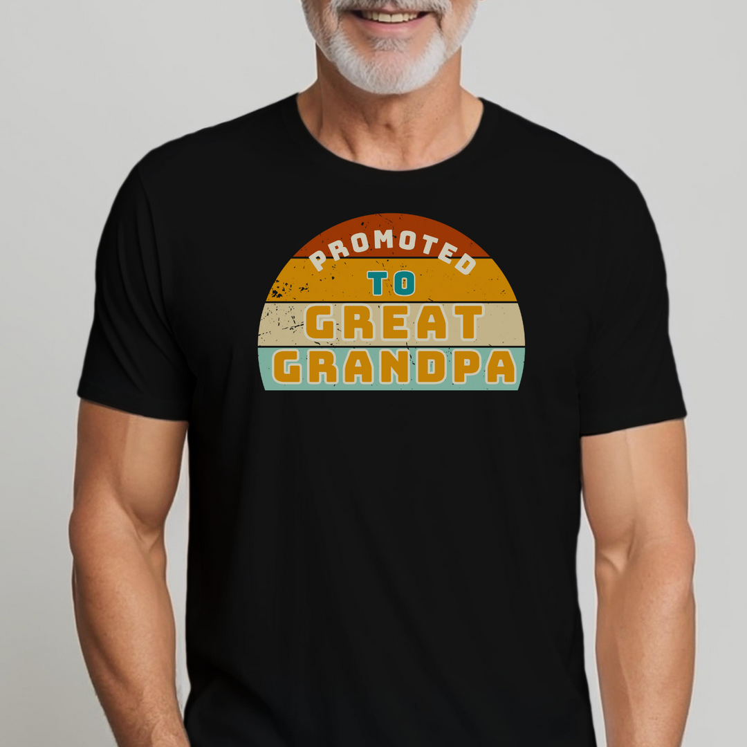 A man in a black Promoted to Great Grandpa tee, smiling. Garment-dyed, ring-spun cotton, relaxed fit, durable double-needle stitching, no side-seams. From Worlds Worst Tees.