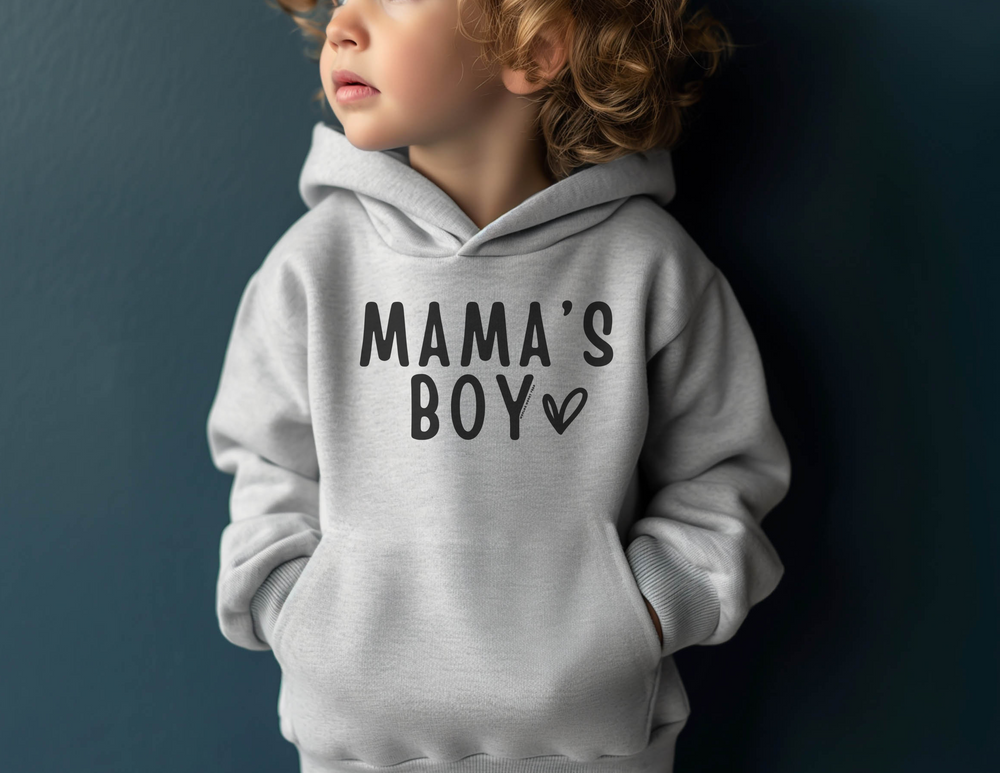 Toddler hoodie featuring a jersey-lined hood, cover-stitched details, and side seam pockets. Mama's Boy Toddler Hoodie in 60% cotton, 40% polyester blend. Designed for durability and coziness.