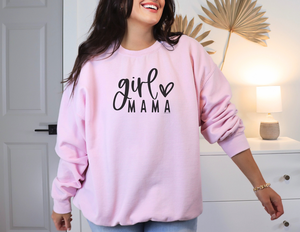 A smiling woman in a pink Girl Mama Crew sweatshirt, showcasing comfort and style. Unisex heavy blend fabric, ribbed knit collar, and no itchy side seams. Ideal for any occasion.