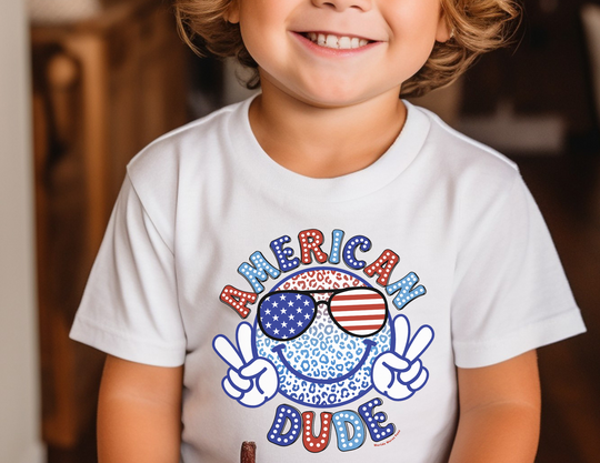 A toddler tee featuring a cartoon face and glasses design, perfect for sensitive skin. Made of 100% combed ringspun cotton, light fabric, tear-away label, and a classic fit. Sizes: 2T, 3T, 4T, 5-6T.