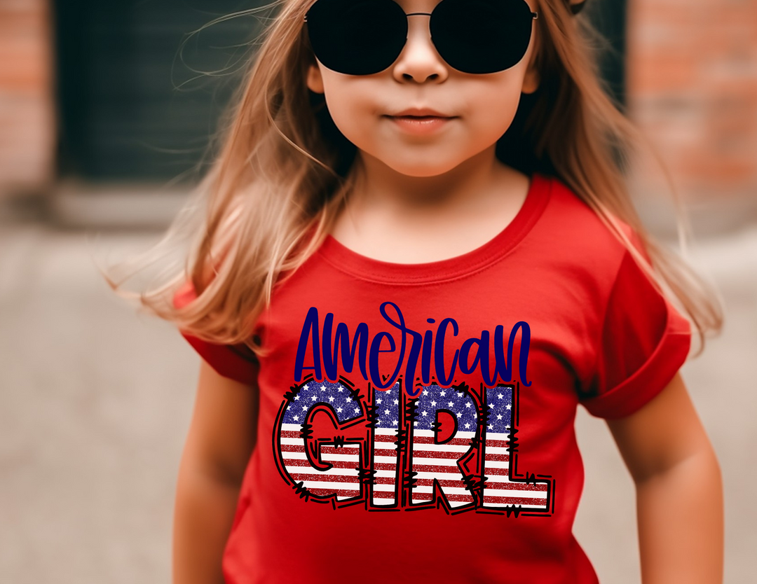 American Girl Toddler Tee featuring a girl in sunglasses and a red shirt. Soft, 100% combed ringspun cotton, tear-away label, classic fit. Available in sizes 2T to 5-6T. Perfect for sensitive skin.