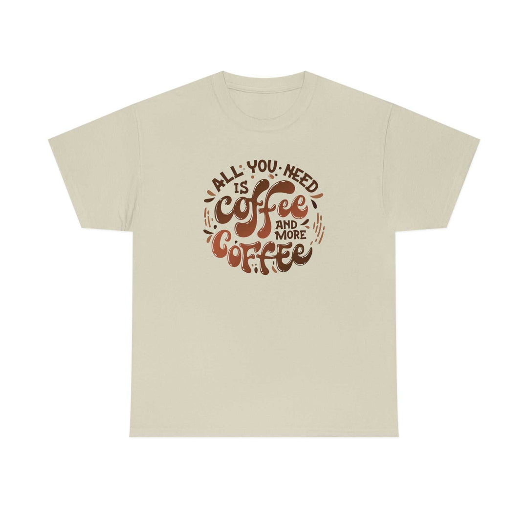 Unisex heavy cotton tee, All You Need is Coffee Tee, featuring brown text on a white shirt. Classic fit with no side seams, ribbed knit collar, and durable tape on shoulders. 100% cotton. Sizes S-5XL.
