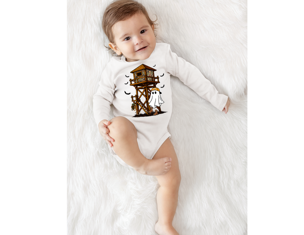 Baby wearing Ghost Hunter Long Sleeve Onesie with Halloween treehouse, ghost, bats on soft white surface, showcasing durable, soft cotton fabric with easy-change snaps.