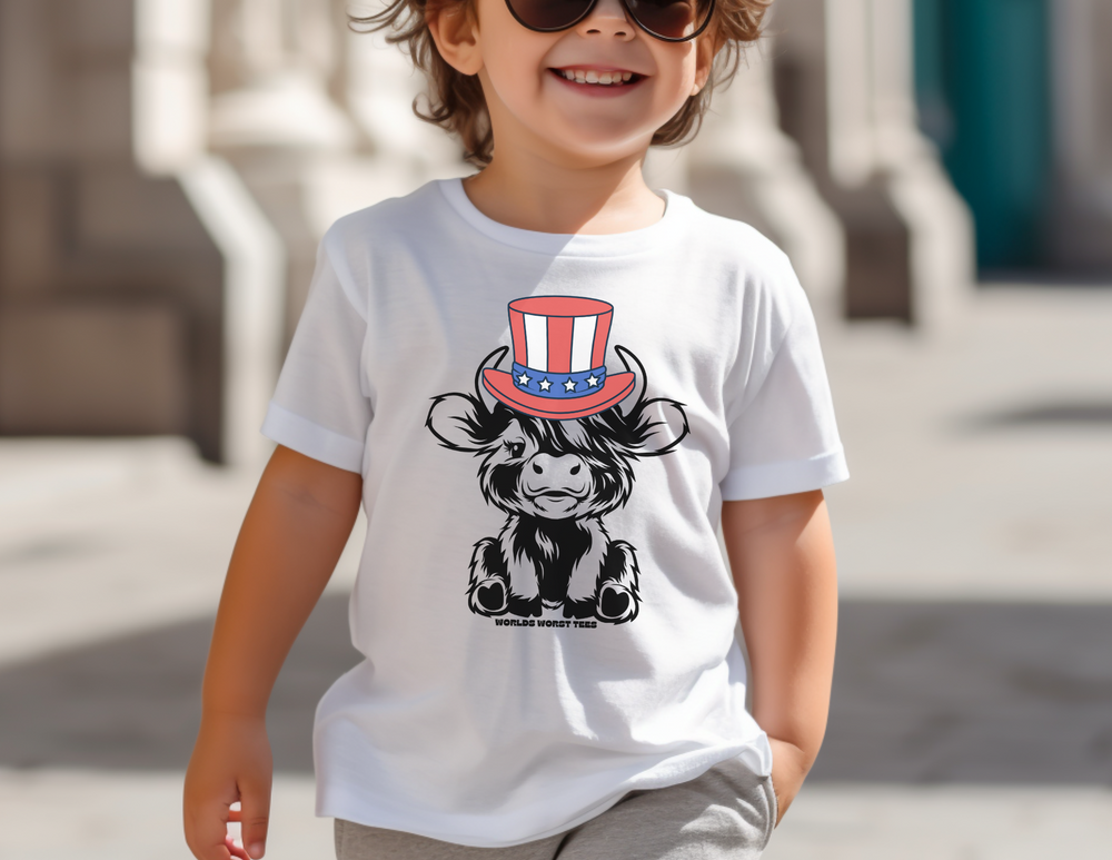 Child in sunglasses and white shirt, smiling at camera. Cow with hat cartoon. Close-ups of child's face and nose. 4th of July Little Dude Cow Kids Tee, 100% cotton, light fabric, classic fit, durable.