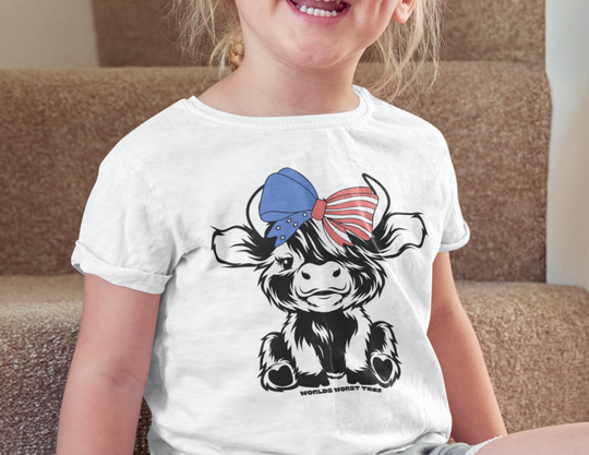A girl in a 4th of July Family Cowgirl Toddler Tee, smiling on stairs. Soft, 100% combed ringspun cotton, light fabric, tear-away label, classic fit. Perfect for sensitive skin.