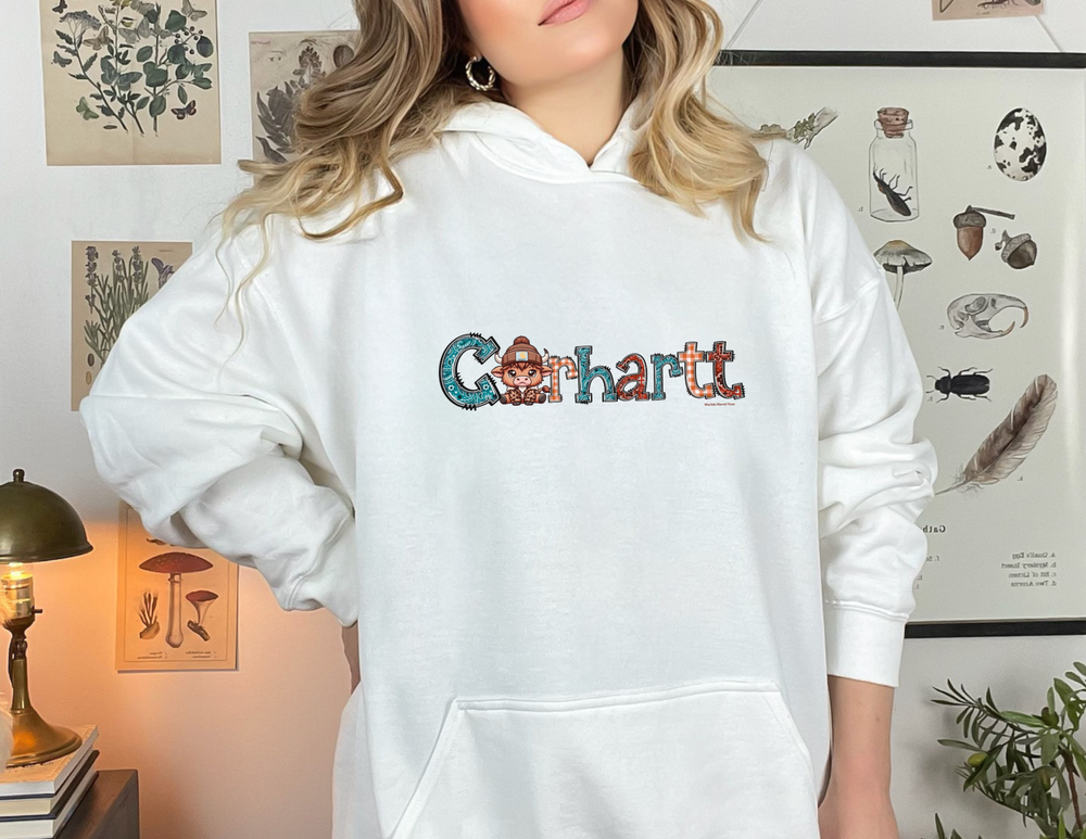 A woman in a white Cowhartt hoodie, a classic blend of cotton and polyester, featuring a kangaroo pocket and drawstring hood. Unisex, medium-heavy fabric for warmth and comfort. Ideal for printing.