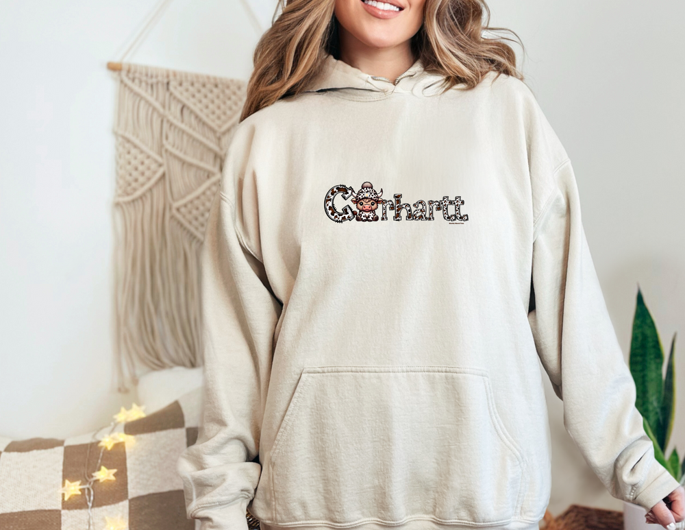 A cozy Cowhartt Cow Hoodie, a blend of cotton and polyester, with a kangaroo pocket and drawstring hood. Classic fit, tear-away label, ideal for printing. From Worlds Worst Tees.