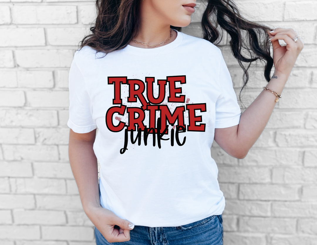 Woman wearing the True Crime Junkie Tee, a classic unisex short sleeve t-shirt, showcasing comfortable fit and soft fabric. Perfect for casual, everyday wear.