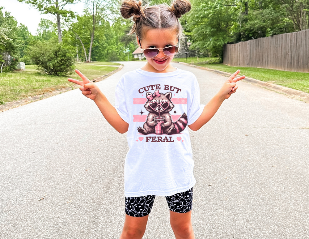 Cute but Feral Kids Tee, a soft, 100% combed cotton t-shirt with a classic fit, designed for active kids' comfort and agility.