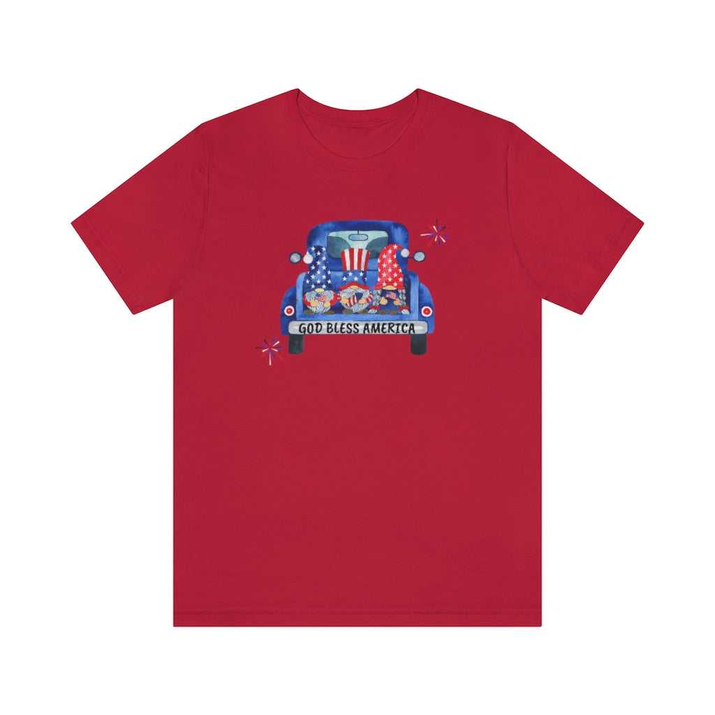 American Gnomies Tee: Red shirt featuring a car with gnomes design. Unisex jersey tee with ribbed knit collar, retail fit, 100% cotton, light fabric, and quality print. From Worlds Worst Tees.