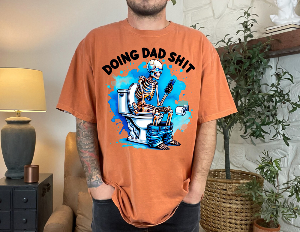 A relaxed fit Dad Shit Tee in ring-spun cotton, featuring a skeleton print. Garment-dyed for extra coziness, with double-needle stitching for durability. From Worlds Worst Tees.